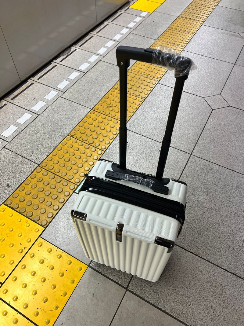A small folding stool waiting on a quiet subway platform